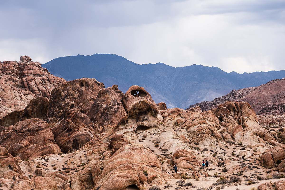 alabama hills brown rock formation near mountain under cloudy sky nature
